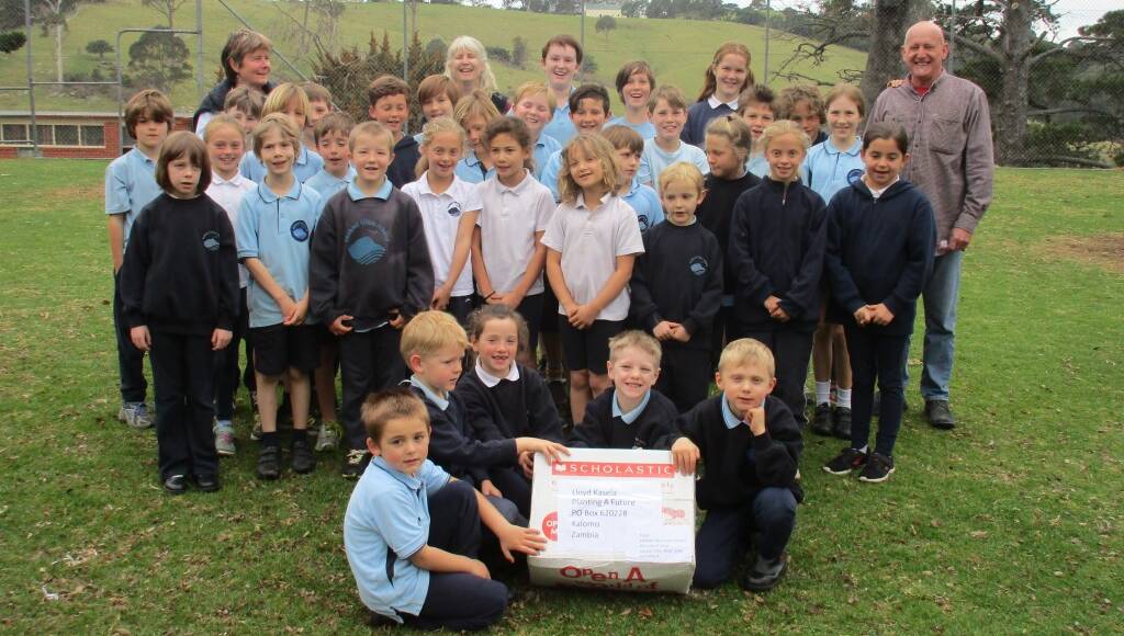 Central Tilba Public School pupils with the box of books culled from their library that is now on its way to a school in Zambia.