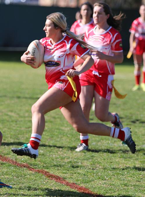 STRONG STRIDE: Elise Johnson pushes forward with the ball in Sunday's grand final. The She-Devils tried hard but went down to the talented Bega Chicks.