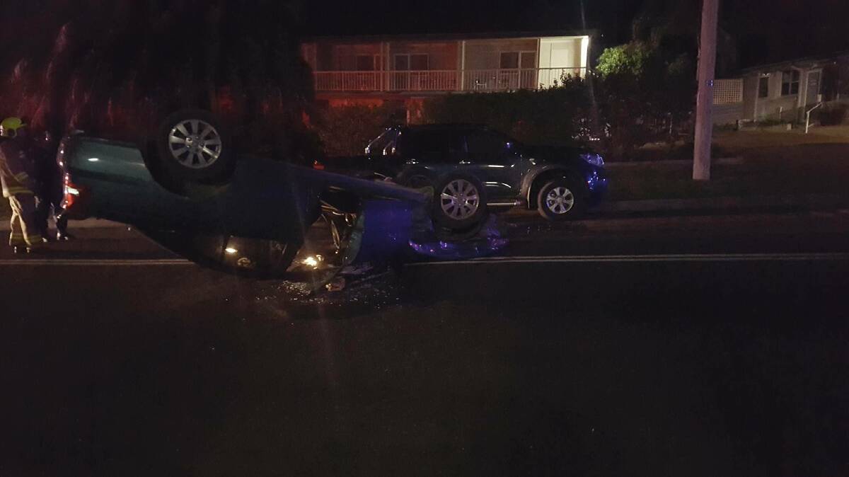 The Holden Commodore rolled after the driver collided with a parked vehicle on the Princes Highway intersection. Photo supplied.  