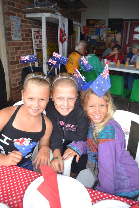 Halle, Rogue and Harmony hand out plates at last year's Narooma Australia Day breakfast held at the surf life saving club. The celebration will be held again at the surf club later this month.   