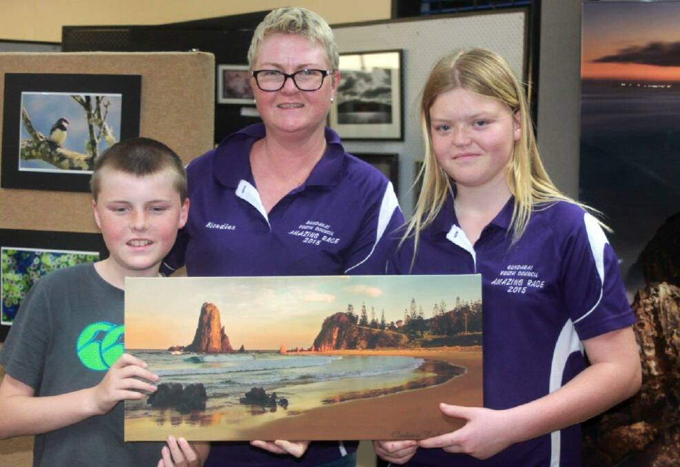 RAFFLE WINNERS: Bec Smart, with children Tom and Bridget, was delighted to win the raffle at the NDCC Photographic Exhibition at Club Narooma over the Narooma Blues Festival weekend. Photo Rosy Williams 