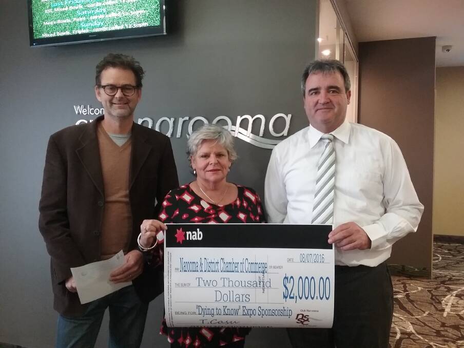 Narooma Chamber president Niels Bendixsen and expo organiser Shanna Provost receive sponsorship from NSSC general manager Tony Casu to host the Dying to Know Expo. 