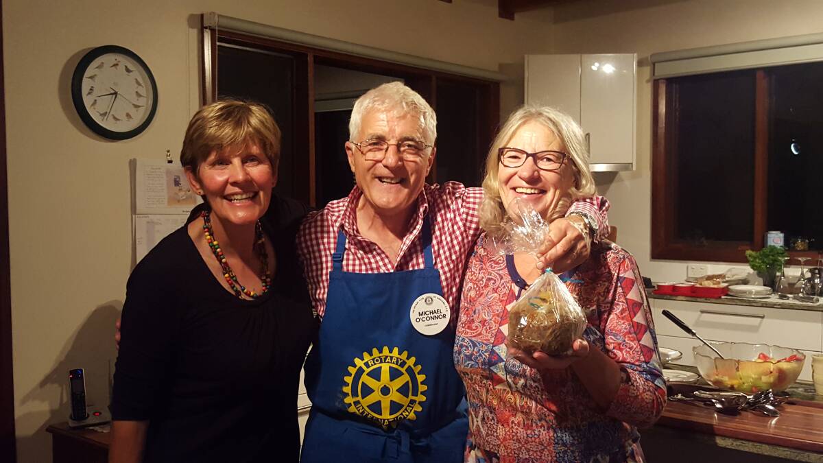 Donna Anderson and Michael O'Connor with Meals on Wheels' Carol Meindl and one of the plum puddings he sold a few a month or so ago making $630 for his epic walk. 