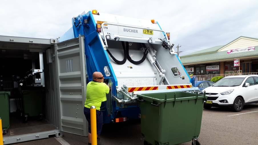 EMPTIED: The Cleanaway truck driver empties the Return and Earn reverse vending machine at Moruya. Photo Jo Rugg