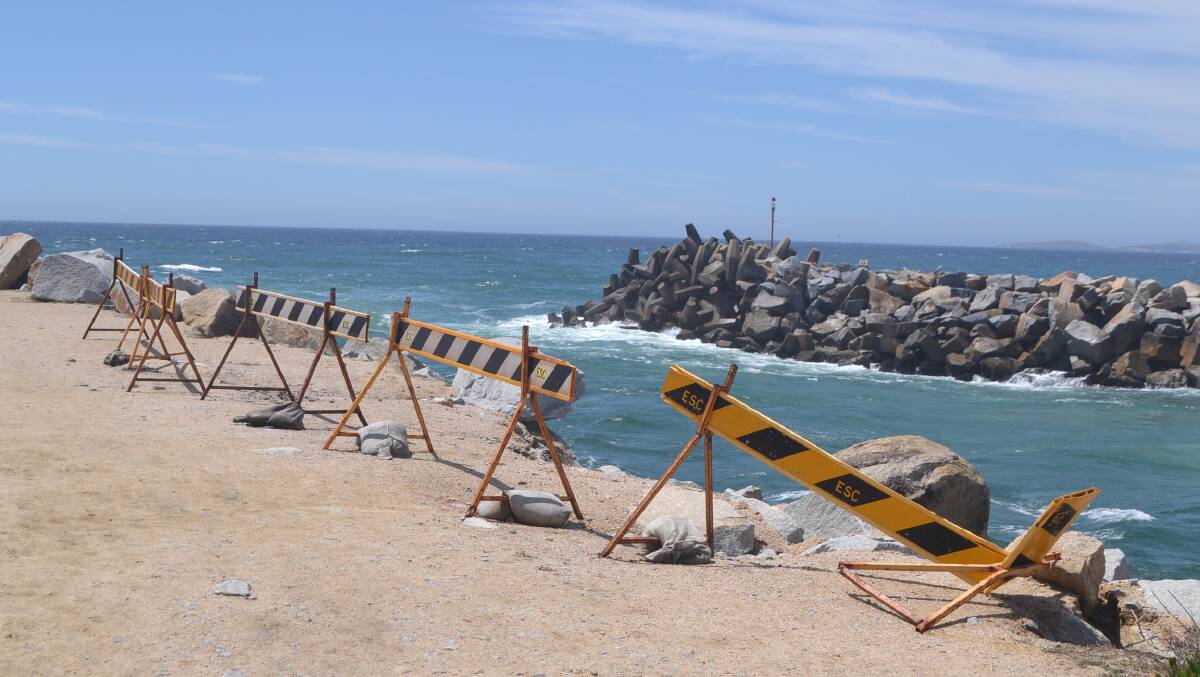 Barriers are still up on the Narooma breakwater after June storms damaged the rock walls.  