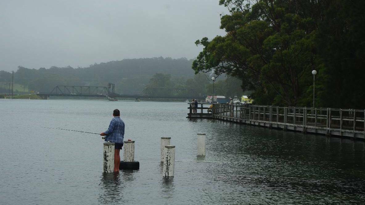APEX PARK: A lone fisherman fishes the high tide from the submerged pontoon at Apex 