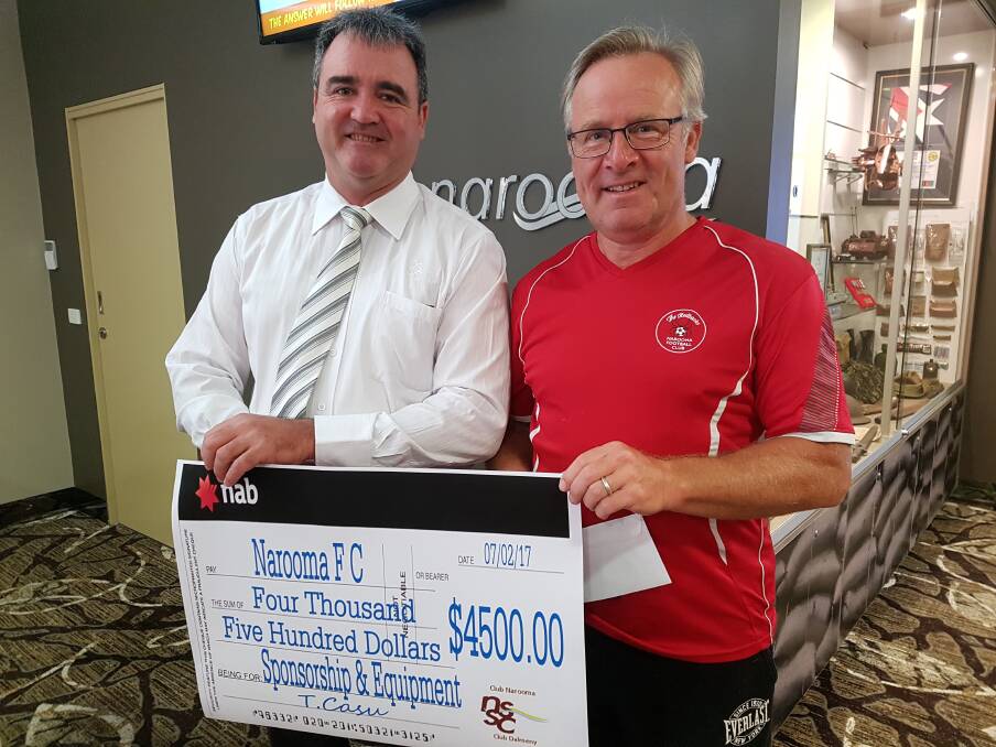 Narooma Sporting and Services Club general manager Tony Casu presents Narooma Football Club's Chris Westoll a sponsorship cheque for $4500. 