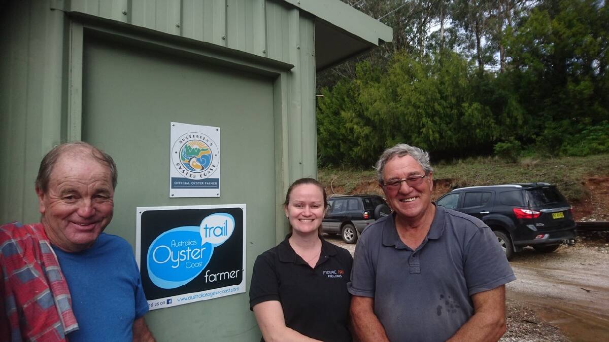 Narooma Oyster Tours operator Bill Dudley meets with Victoria Fleming of Mosaic Fire Pyrotechnics and local grower David Maidment to plan the opening night fireworks.
