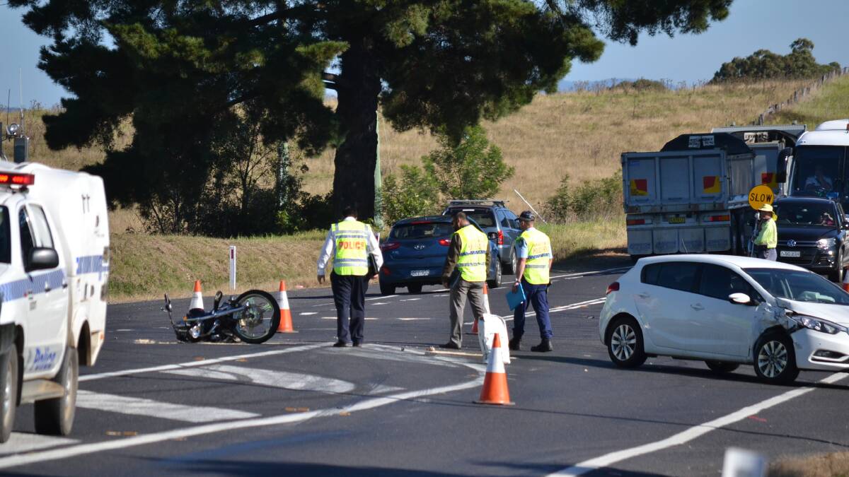 Police investigators at the scene of a crash involving a hatchback and a motorcycle at the intersection of Hector McWilliam Drive and the Princes Highway on April 27.