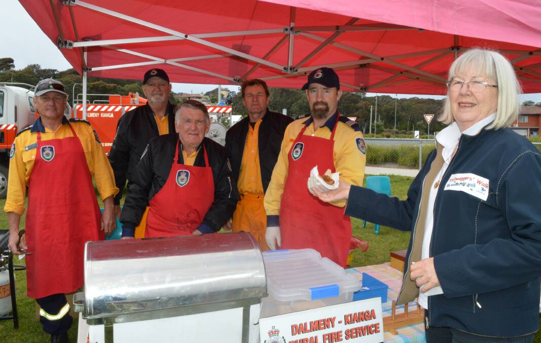 RFS members Mick Anderson, Kevin Cain, Wayne Bell, Andy Swann and Greg Hill serving  Margaret Burson of Mogo.