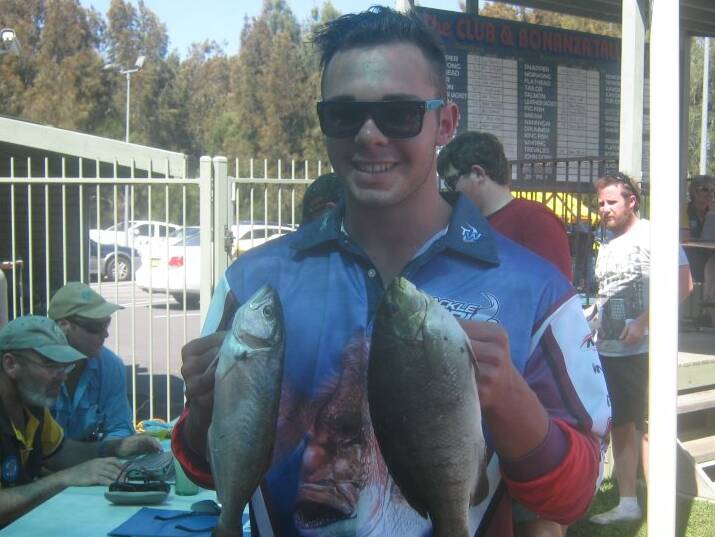 BRACE: Reece Nye holds his winning tailor and blackfish from the junior division at the weigh in. He also caught the heaviest bream for a junior angler.  