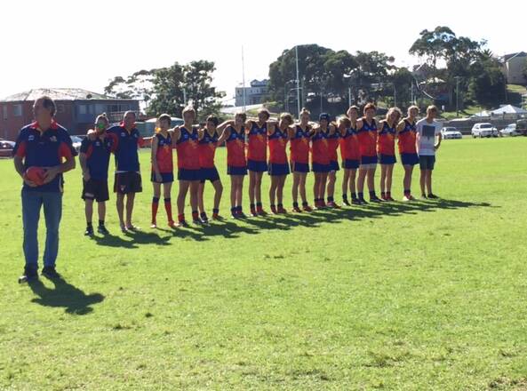 Narooma under 16s unfurl their flag.