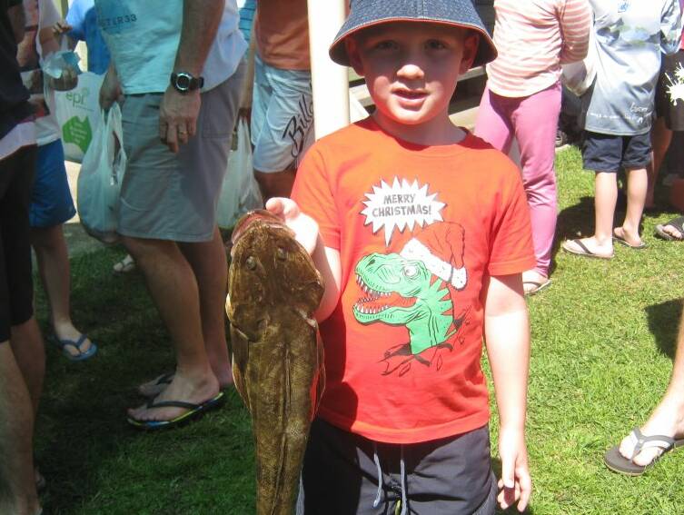 SUB JUNIOR: Harvey Develynes was all smiles when he won prize for this flathead. The flathead tipped the scales at just more than one kilogram. 