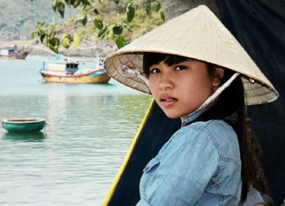 The fisherman's daughter.As we wandered through a fishing village off the coast of Nha Trang,Vietnam, she was standing under a tree.I couldn't help but think how different her life must be compared to our teenagers life back home.March 2014. Photo: Joanne Rovere