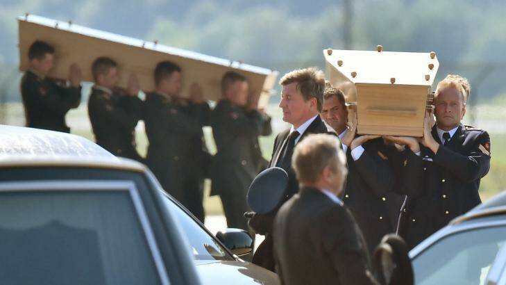 Dutch military men carry coffins containing the bodies of MH17 victims during a ceremony at Eindhoven Airbase after a Hercules transport plane landed from Ukraine.