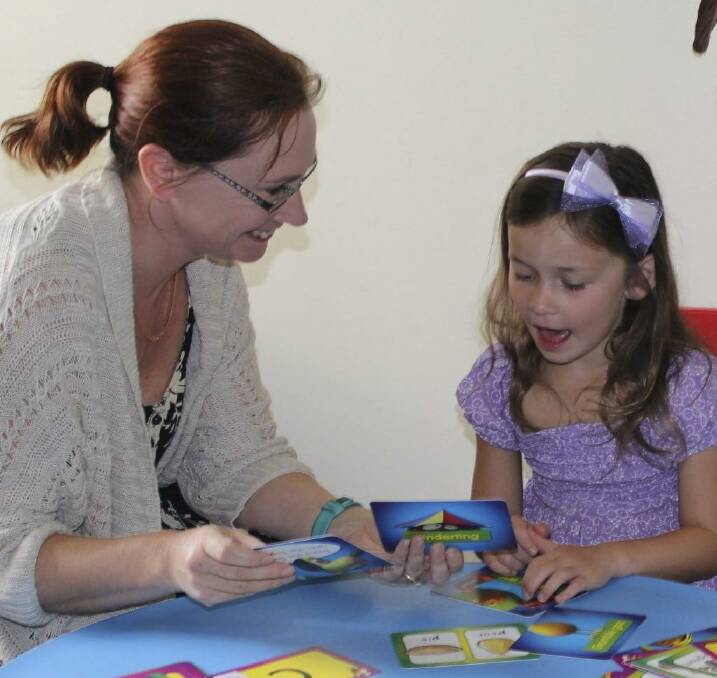 Paediatric speech pathologist, Elise Cassidy, at work with one of her charges.