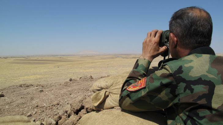 Peshmerga soldier looks over no-mans-land towards ISIL controlled areas of northern Iraq. Photo: Ruth Pollard