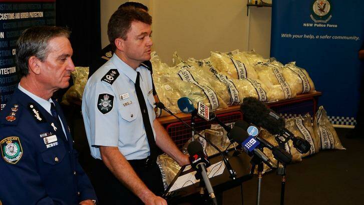 NSW Police Commissioner Andrew Scipione and AFP Commissioner Andrew Colvin with a quarter of the drugs seized in the operation. Photo: Daniel Munoz