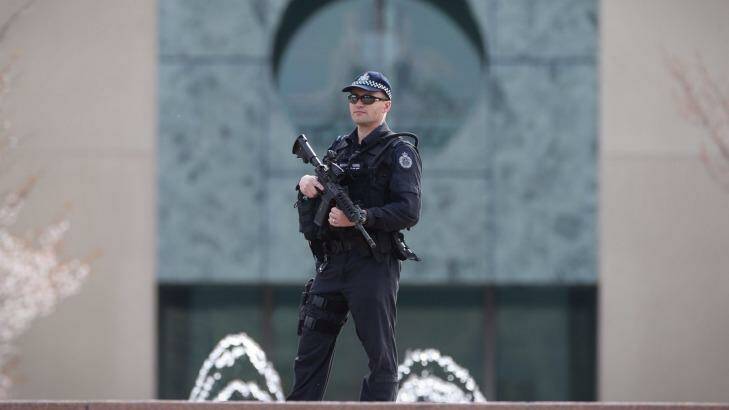 An AFP officer guards the perimeter of Parliament House. Photo: Andrew Meares