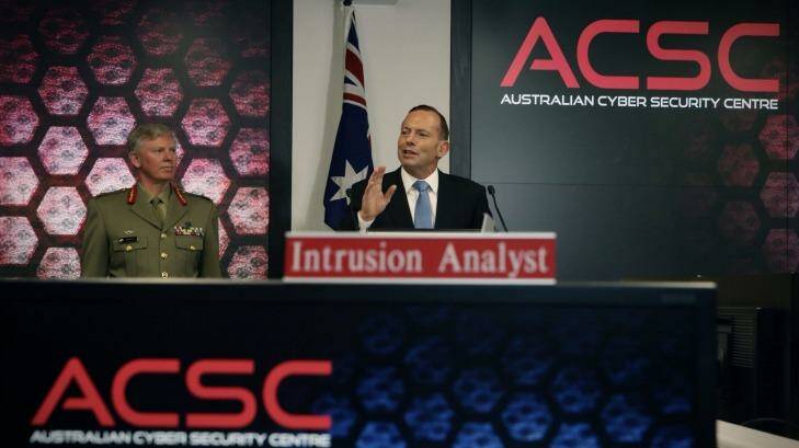 Mr Abbott, pictured with General Stephen Day, announces a cyber security review. Photo: Andrew Meares