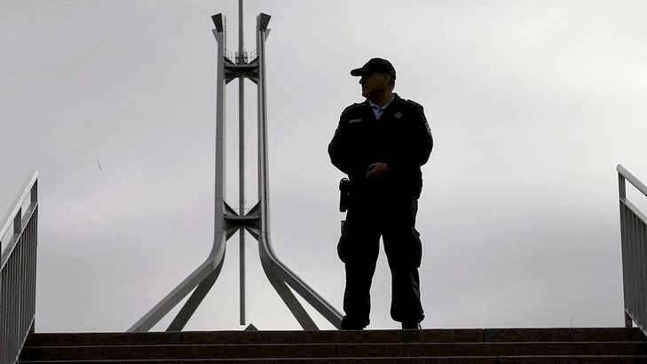 Australian Federal Police officers lock down the ministerial entrance to Parliament House in Canberra on Monday. Photo: Andrew Meares
