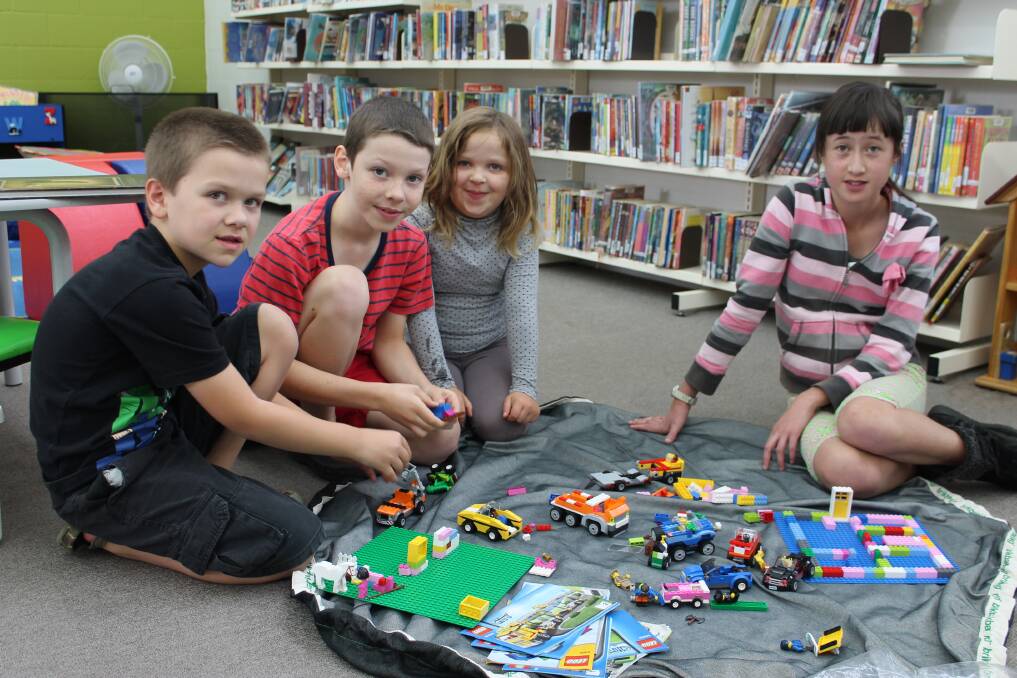 Playing with Lego at Bega library as part of the shire’s Easter holiday activities are (from left) Oliver, Sebastian and Xanthe Dawd along with Jacinta Tarlinton. 