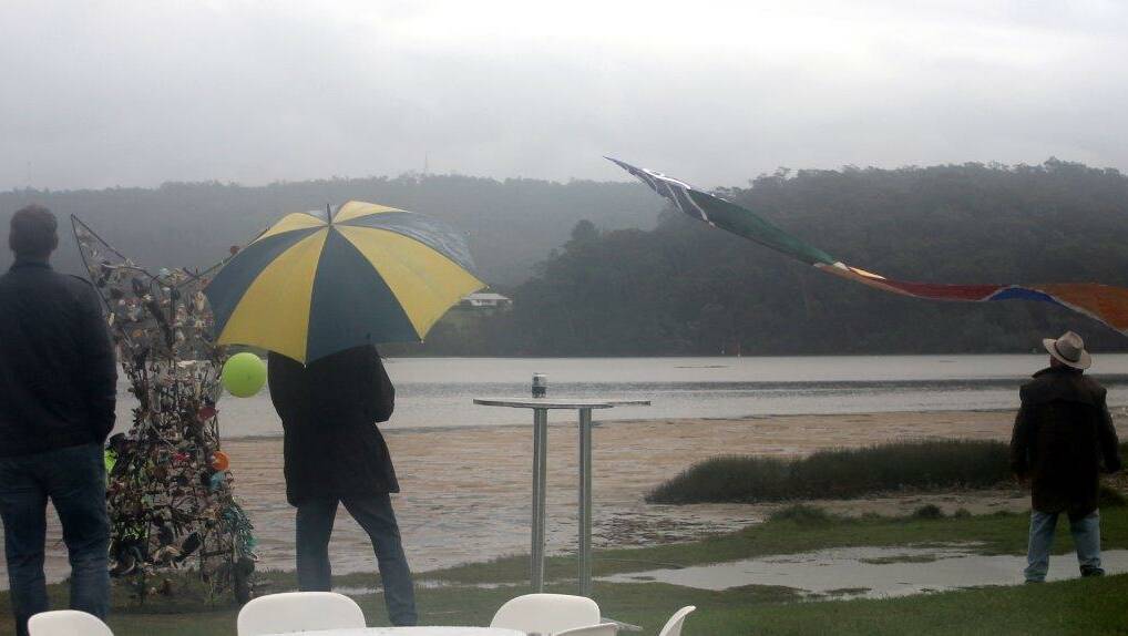 UMBRELLAS: Umbrellas were often needed to view the kite flying. Photo by Rosy Williams 