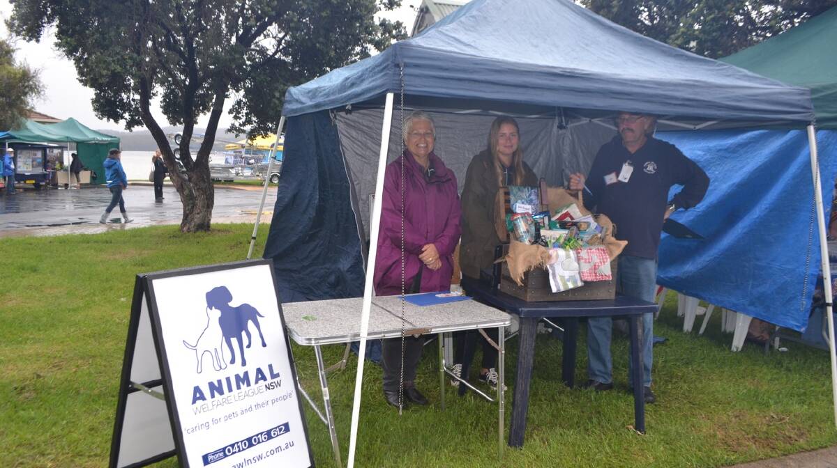 AWL STALL: The AWL branch's Lynda Ord with Swedish visitor Tove Brynteson from Umea and Rob Scholberg at the Narooma Oyster Festival. Photo Stan Gorton