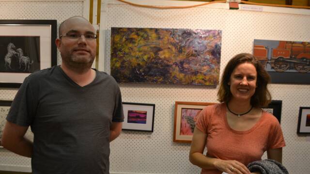 
ACRYLIC WORK: Christian and Nadja De Brennan of Bermagui with Nadja’s acrylic abstract named “Opal” at the Montague Arts and Crafts Society Easter Exhibition.
