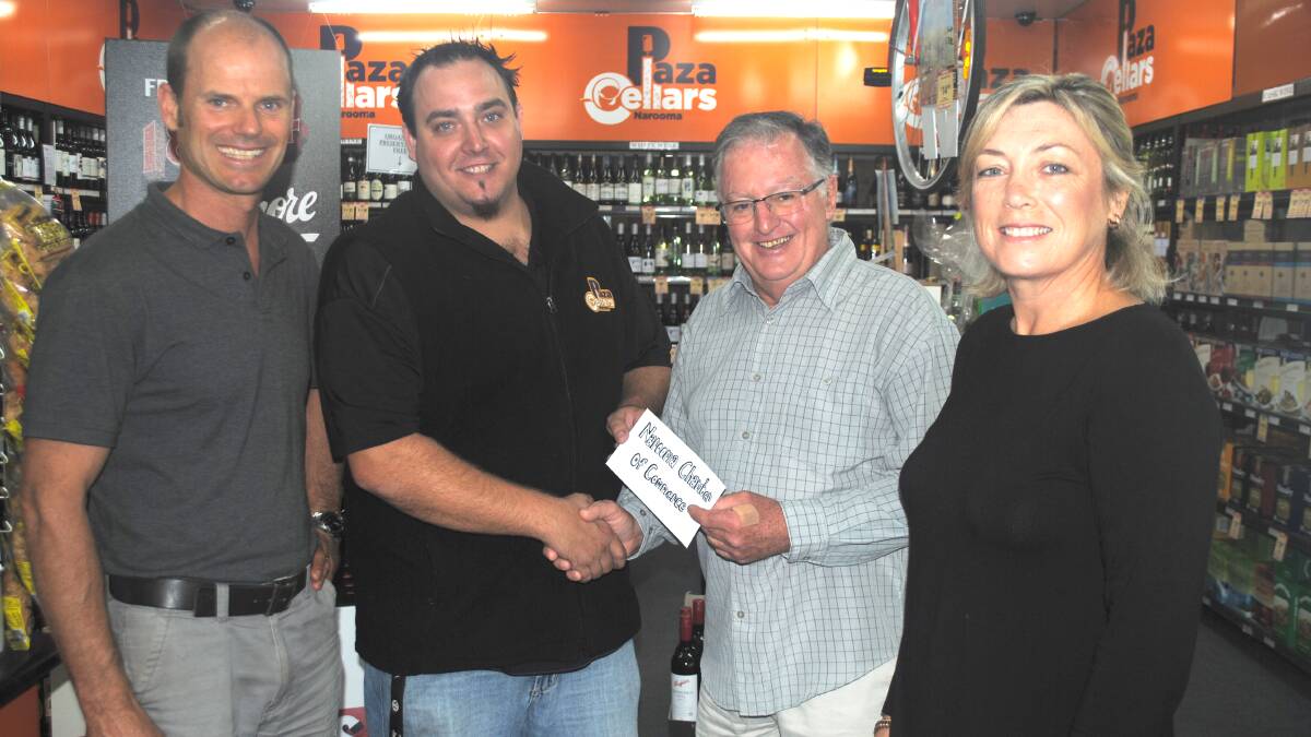 WELCOME SUPPORT: Narooma Plaza Centre manager Mark Anderson and Plaza Cellars manager Jethro De Vries hand over the proceeds from the beer and wine bar at Narooma Oyster Festival to Narooma Chamber treasurer Paul Dixon and festival spokesperson Cath Peachey.  