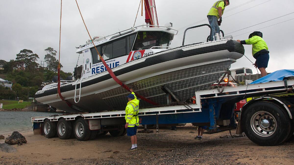 VESSEL LAUNCH: The new 10.2 metre Naiad rescue vessel is launched by Marine Rescue Narooma at the Narooma Bridge on Thursday in the rain. Photo by Brian Gunter 