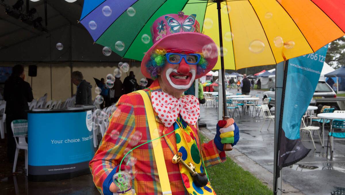 COLOURFUL CLOWN: Patrick the clown was a colourful fixture on a grey day at the 2014 Narooma Oyster Festival, Photo Toby Whitelaw 