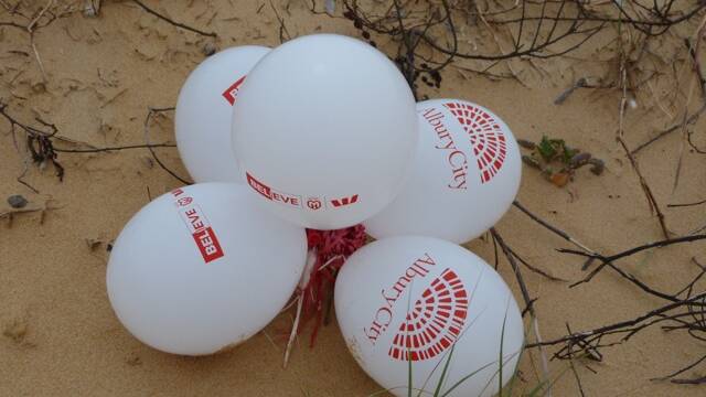 BALLOON POLLUTION: The balloons from an Albury football match were found on a Bermagui beach the next day. 