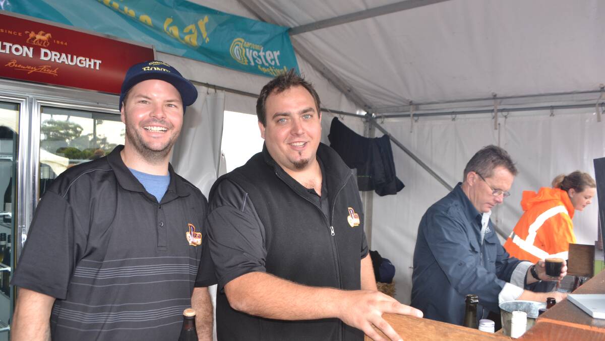 THIRSTY CROWD: Cameron Bargwanna and Jethro DeVries from the Narooma Plaza Cellars keeping the crowd supplied at the Narooma Oyster Festival. Photo Stan Gorton 