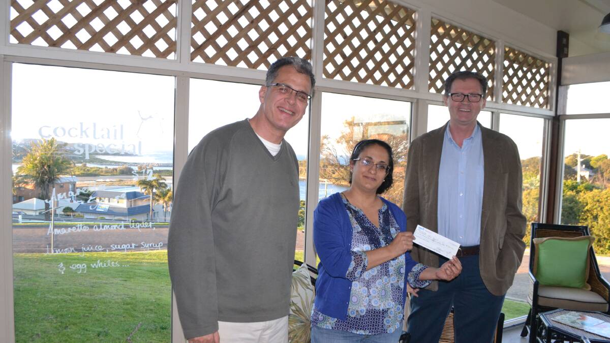 OCEAN LOUNGE: In the Ocean Lounge at the Whale Motel are former and current Narooma chamber presidents Orit Karny Winters and Matt Deveson handing over the cheque to mayor Lindsay Brown. 