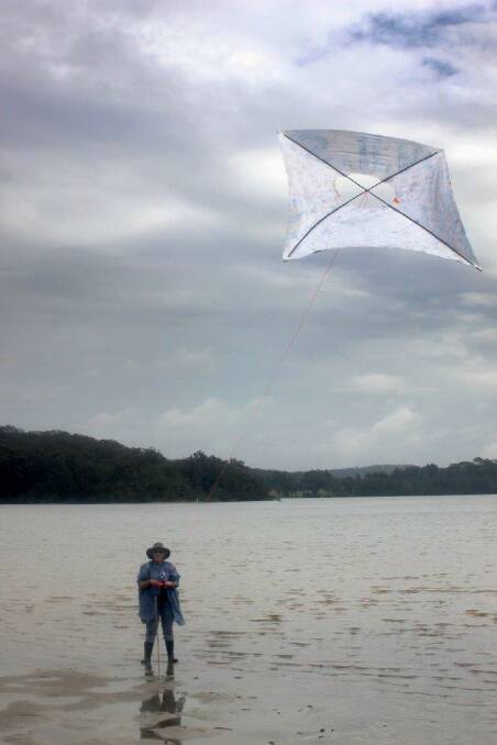 KITE MASTER: Chris Perrott masters the art of kite flying in tricky conditions...gum boots needed! Photo by Rosy Williams   