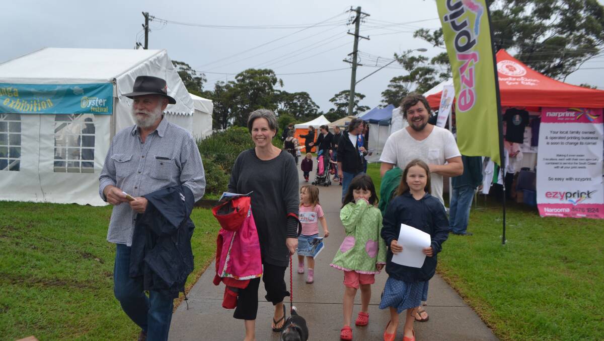 FAMILY BEFORE: The Fisse family of Narooma arrives at the Narooma Oyster Festival prepared for the rain. Photo Stan Gorton 