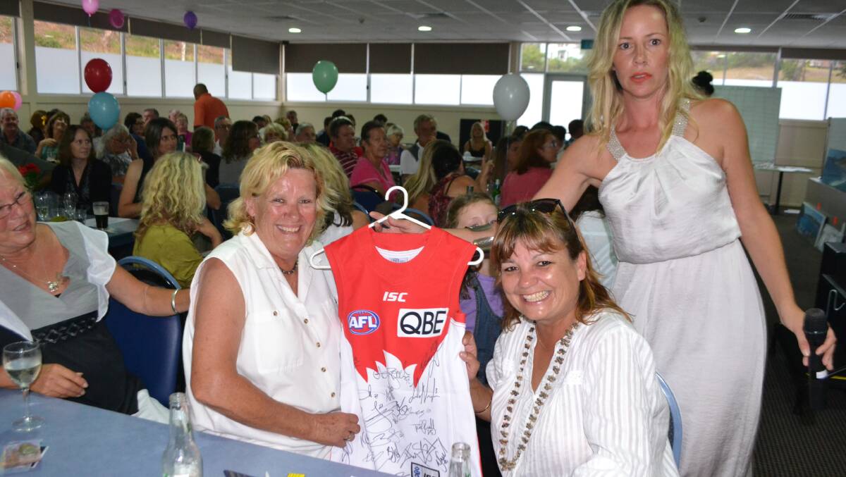 SWANS JUMPER: A Sydney Swans AFL jumper was a popular item in the auction.