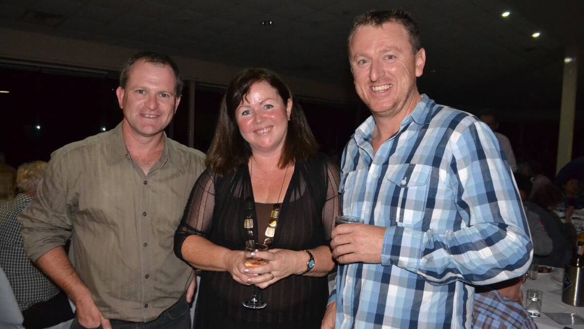 FLYING START: Pilot Tim Gilbo and Nutsy Fairweather who are stating the South Coast Seaplanes flight-seeing tours in Moruya are pictured with Eurobodalla economic development officer Sarah Cooper at the Narooma Oyster Festival dinner at the Narooma Golf Club on Saturday night. Photo Stan Gorton 