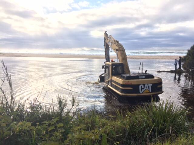 Photos of the excavator opening Corunna Lake, south of Narooma