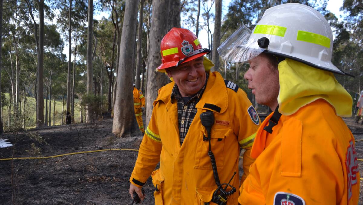 The Tilba RFS brigade mops up after the out of control pile burn