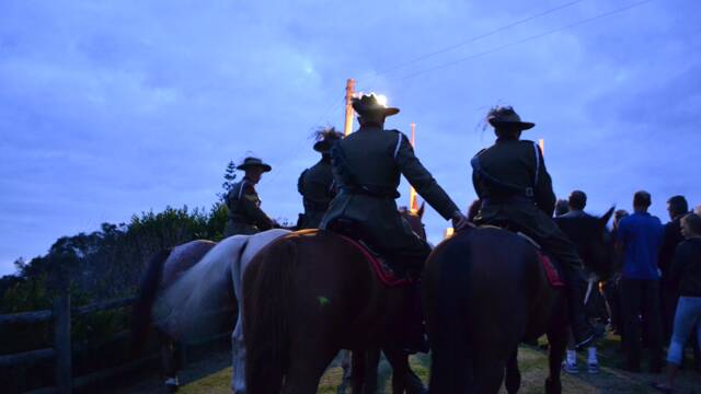 MOUNTING UP: 7th Bemboka Light Horse and their horses head down to the Bermagui War Memorial at the start of the dawn service.