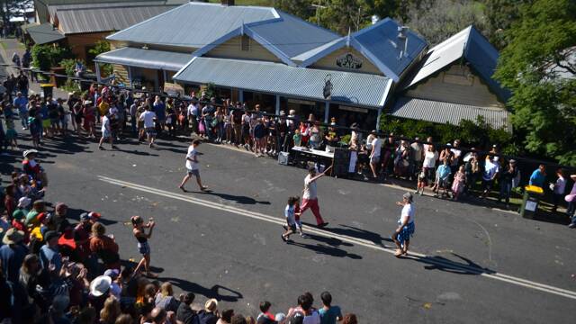 EGG ACTION: The egg toss is always a big hit at the Tilba Festival, as seen from the upper deck of The Drom Hotel. Winners Tony Cameron and George Harris celebrate.