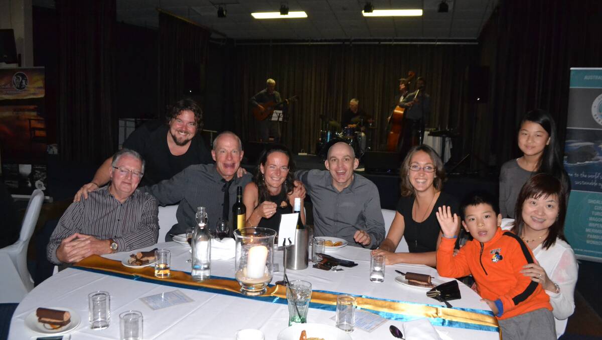 BIG TABLE: Narooma locals Paul Dixon, Adrian Fisse, Chris Spurgeon, Karen and Andrew Duggan with visitors Laura McLennan and Michelle Lam from the Chinese language New Land Magazine and her kids Kingsley and Angela at the Narooma Oyster Festival dinner at the Narooma Golf Club on Saturday night. Photo Stan Gorton 