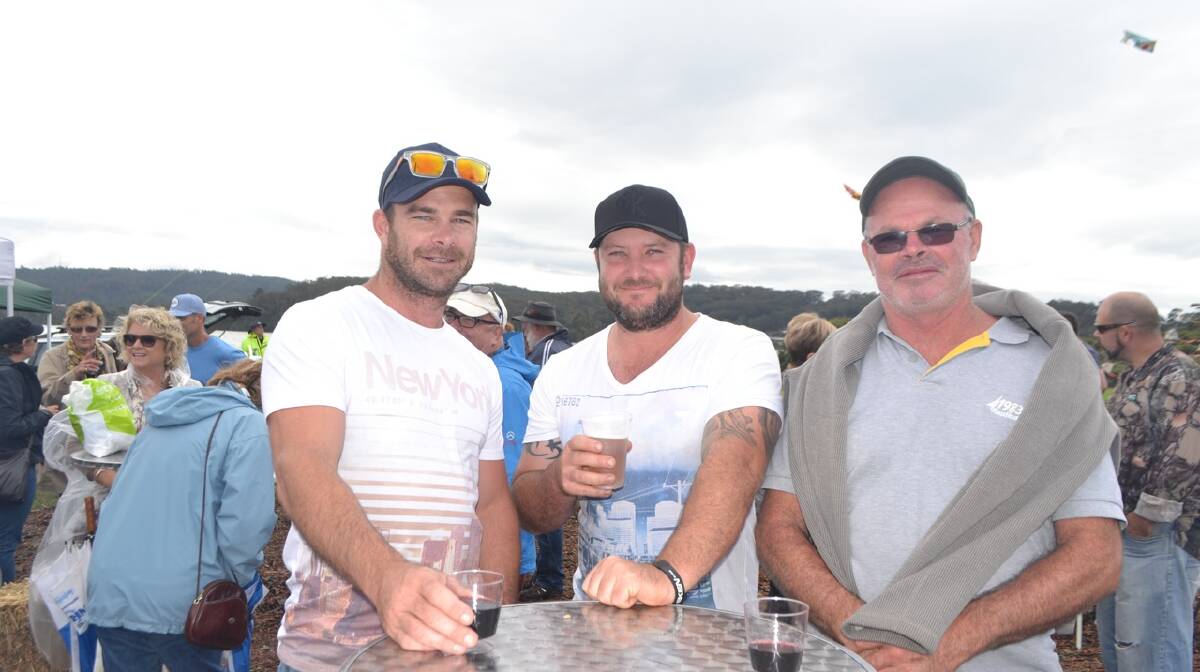 WARMING UP: Loosening up for the Narooma Oyster Festival oyster shucking contest is eventually silver medal winner Steve Connell (centre) with Daniel and Mike Leth. Photo Stan Gorton