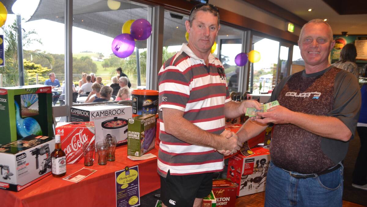FISHY FUNDS: Publican Paul O’Brien handing over $3000 raised during the Narooma Flathead Classic.