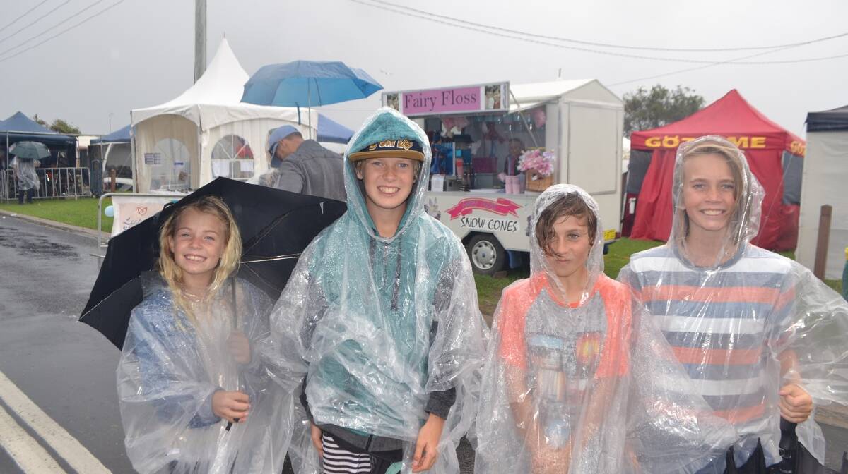 PONCHO KIDS: Wearing their rain ponchos are Sienna Anderson, Ethan Anderson, Patrick Stewart and Jarrah Seaman at the Narooma Oyster Festival. Photo Stan Gorton