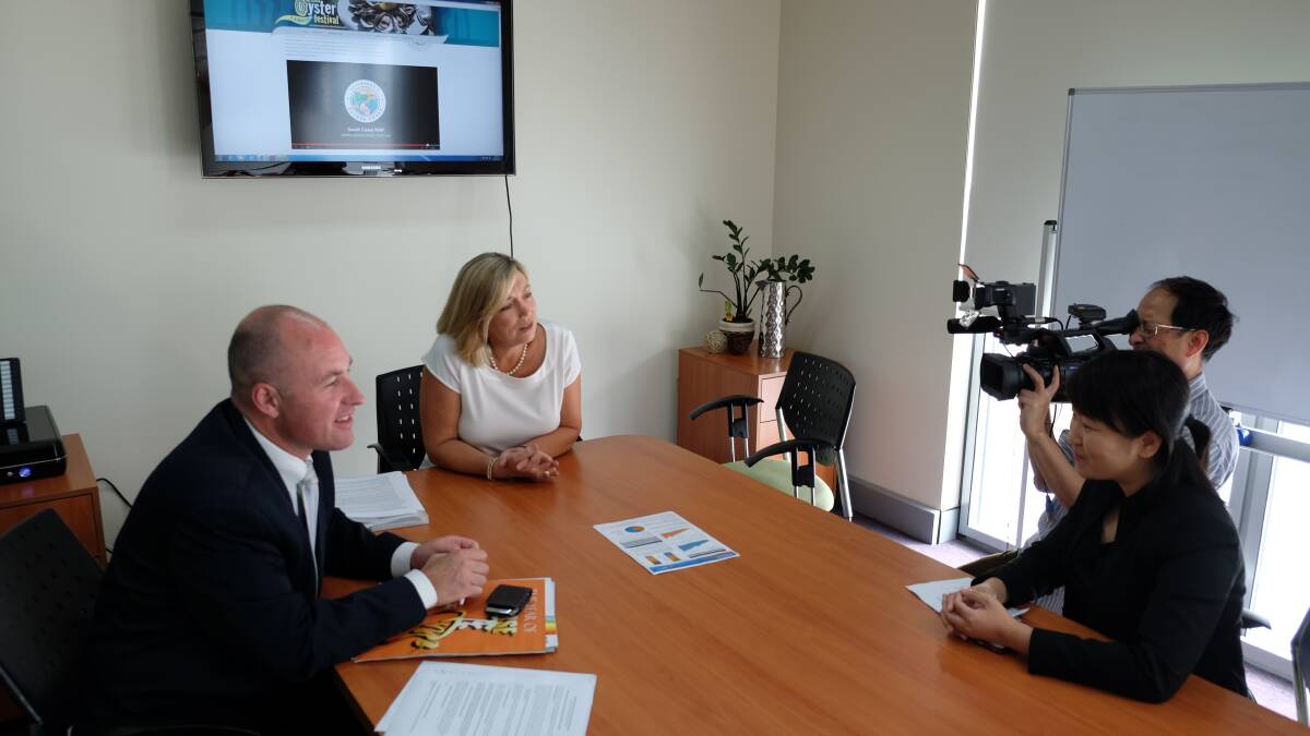 SELLING NAROOMA: Festival spokesperson Cath Peachey and Australia’s Oyster Coast executive officer Andrew Wales being interviewed in Sydney last week by leading Australian-based Chinese and Indian print, radio and television journalists. 