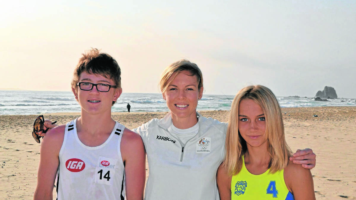 NAROOMA CONNECTIONS: Ex Olympic skeleton racer Melissa Hoar with young Narooma athletics stars Connor Griffiths and Lilly Bennett on Narooma surf beach.