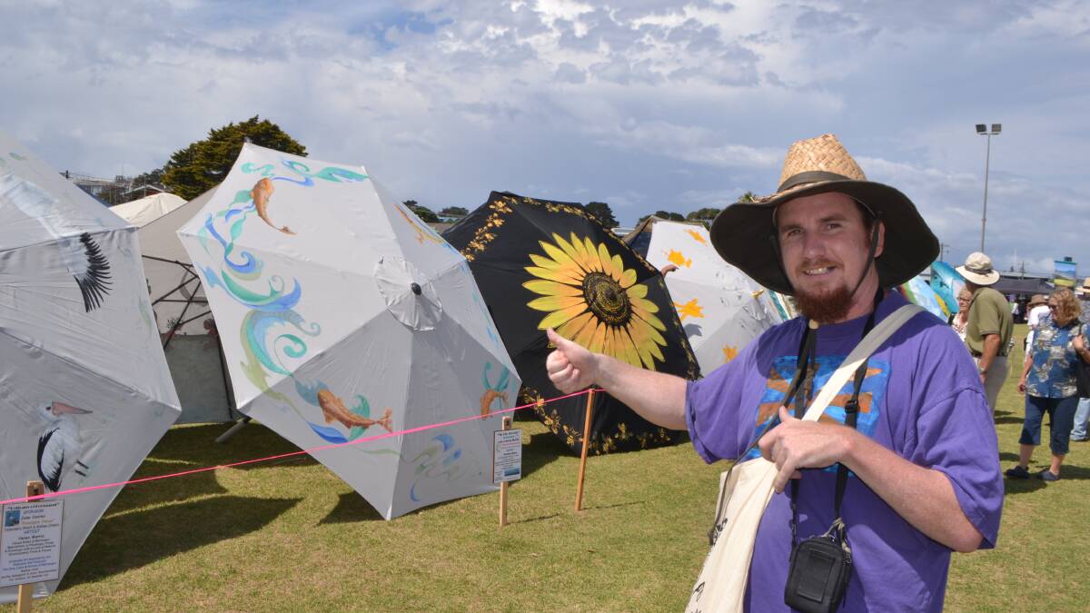 UMBRELLA AUCTION: Narooma artist Bryn Waterman checks out the “Umbrellas of Bermagui. 